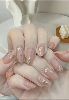 a woman's hands with long, shiny nails