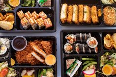 four plastic trays filled with different types of sushi and other foods on them