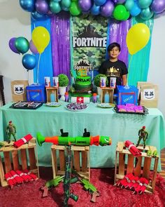 the table is set up with toys and decorations for a fortnite birthday party