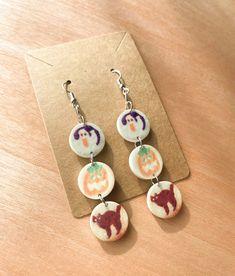 the earrings are decorated with images of dogs