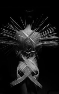 black and white photograph of a woman's torso with hair blowing in the wind