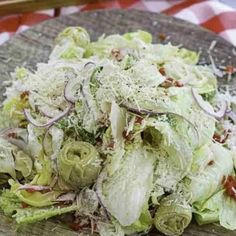 a wooden plate topped with lettuce and onions