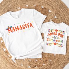 two t - shirts with the words mama and daughter on them sitting on a mat