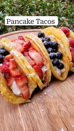 three crepes with strawberries, blueberries and raspberries on them