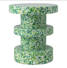 three stacks of green sprinkles stacked on top of each other