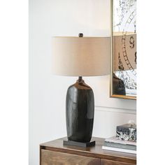 a table lamp sitting on top of a wooden dresser