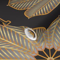 an artistic gold and black wallpaper design with leaves on the side, featuring metallic foil