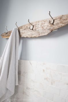 a towel hanging on a wooden rack in a bathroom