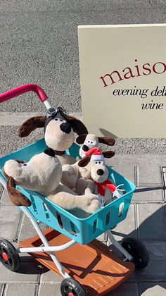 two stuffed dogs in a wagon on the sidewalk