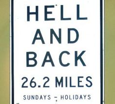 a street sign that says hell and back 26 2 miles on the side of a wall