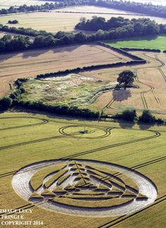an aerial view of a circular maze in the middle of a field
