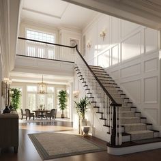 a staircase leading up to a living room and dining room in an elegant white house