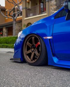 a blue car is parked on the street