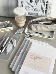 an assortment of office supplies sitting on a desk