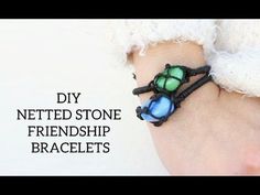 the bracelet is made out of black cord and has three colorful glass beads on it