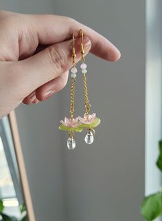 "Add something extra to your outfits with these lily pad lotus flower earrings! Made with gold plated wire, shrink plastic, and glass beads. The dangle length is around 6.5cm/2.5\". Each pair is lovingly handmade! 🎀 CARE INSTRUCTIONS 🎀 * Avoid getting your jewelry wet * Avoid perfumes or sprays * Store in a cool, dry place" Drop Flower Earrings, Plastic Flower Earrings, Dangle Flower Earrings, Lily Pad Earrings, Water Lily Earrings, Crystal Earring Ideas, Wind Chime Earrings, Wire Flower Jewelry, Lotus Flower Earrings