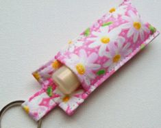 a pink flowered fabric key fobring has a metal ring on it's end