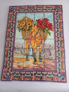 an artistic tile mural depicting a horse carrying flowers