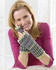 a smiling woman wearing knitted gloves while talking on the phone