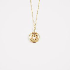 a gold plated necklace with a circular design on it