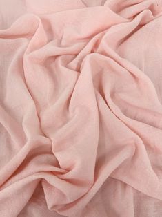 a pink blanket is laying on top of a white bed sheet and it looks like something out of space