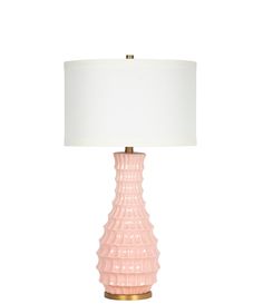 a pink lamp with a white shade on it