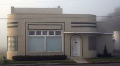 a house with a white door and windows on a foggy day in the suburbs