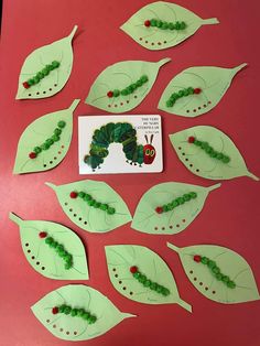 the very hungry caterpillars are made out of paper and cut into leaf shapes