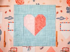 a piece of fabric with a heart in the center on top of a table cloth