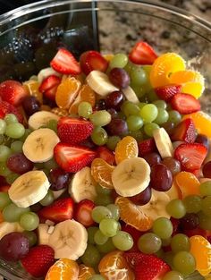 a glass bowl filled with lots of different types of fruit