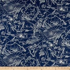 a blue and white map print fabric with lines on the top, in front of a ruler