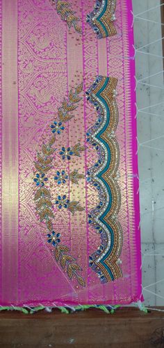 a pink and blue sari with intricate designs on it