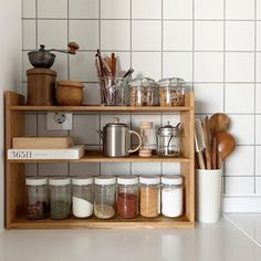 a wooden shelf filled with lots of kitchen items