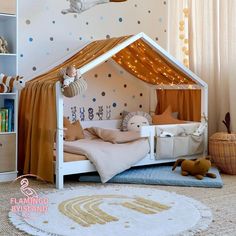 a child's bedroom with a tent bed in the middle and stars on the wall