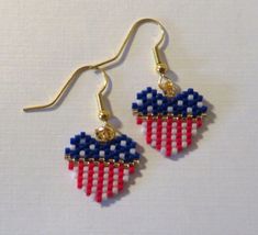 red, white and blue beaded earrings with gold earwires hanging from hooks