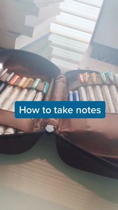 an open suitcase filled with crayons on top of a table