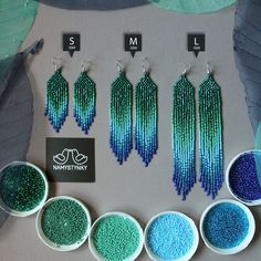 five different colors of seed beads in bowls next to each other with matching earrings on them