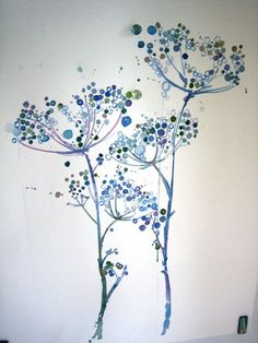 an abstract painting of blue flowers on a white wall