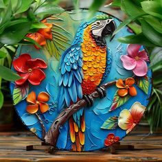 a colorful parrot sitting on top of a tree branch next to some flowers and leaves