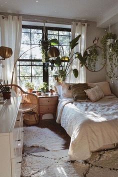 a bed room with a neatly made bed and lots of plants