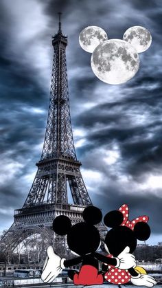 mickey and minnie mouse in front of the eiffel tower