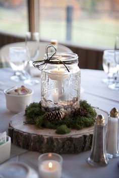 a glass jar filled with candles sitting on top of a table