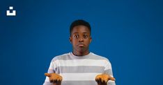 a young man is holding out his hands in front of the camera and looking at the camera