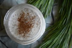 an overhead view of a drink in a glass with cinnamon sprinkles