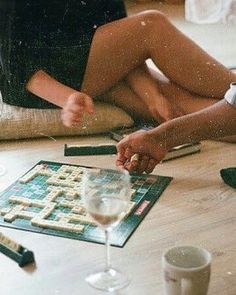 a woman sitting on the floor playing a board game