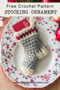 a crocheted christmas stocking ornament on a plate