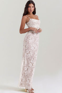 Description: Delicate lace dresses for sophisticated women seeking versatile elegance. Our boutique presents a vintage-inspired outfit - a two-piece lace dress featuring a stunning long-sleeve shrug in cream. Embrace timeless glamour with a floral lace sleeveless maxi dress, highlighting ruched detailing at the waist, a long fishtail cut, and delicate spaghetti shoulder straps. This feminine matching set embodies sophistication, offering flexibility with a lace-up closure at the back, allowing the garments to be worn together or separately. House Of Cb Artemis Dress, Artemis Dress, White Lace Long Sleeve Dress, Long Sleeve Shrug, White Lace Maxi Dress, White Lace Maxi, White Lace Dress, Vintage Inspired Outfits, Lace Print