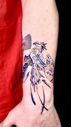 a person with a bird tattoo on their arm