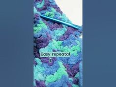 a crocheted blue and green tie with the words easy repeat on it