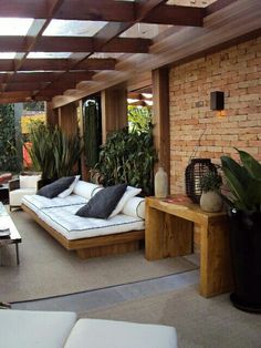 a living room filled with lots of furniture and plants